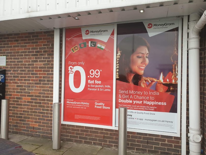 MoneyGram Diwali window posters on a retail unit